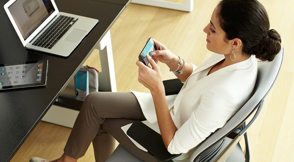 woman using mobile device at work