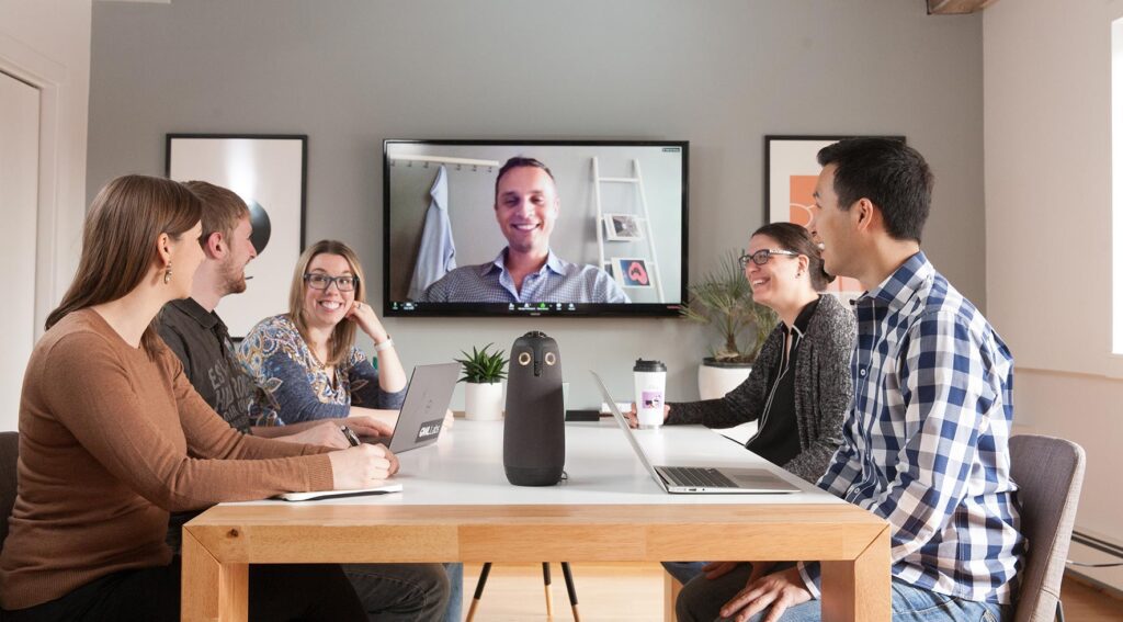 people meeting with remote participants using technology