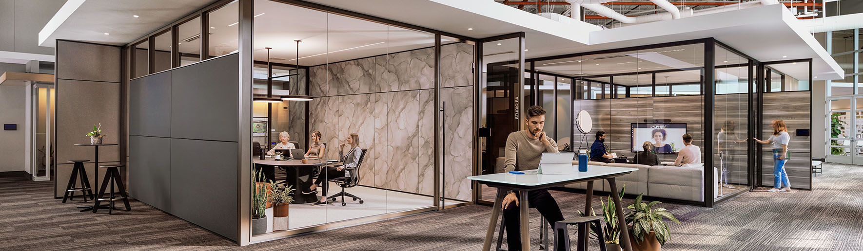 people working in demountable wall meeting rooms